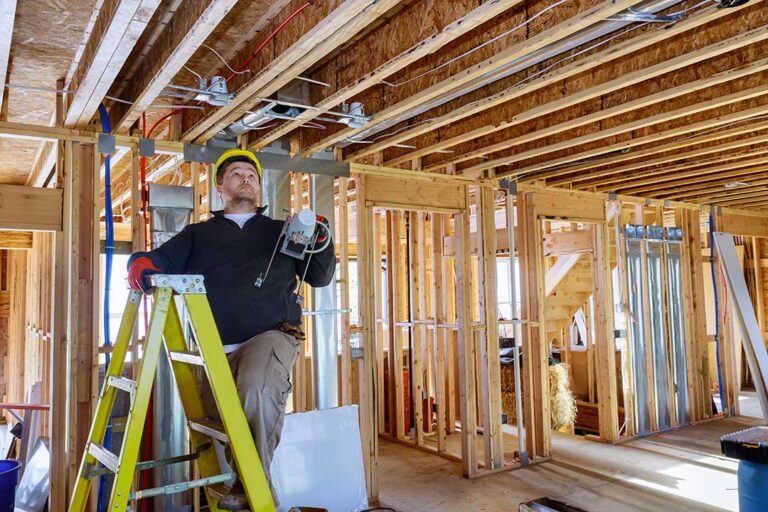 A person adjusting a loose light bulb in a ceiling fixture in a residential living room.